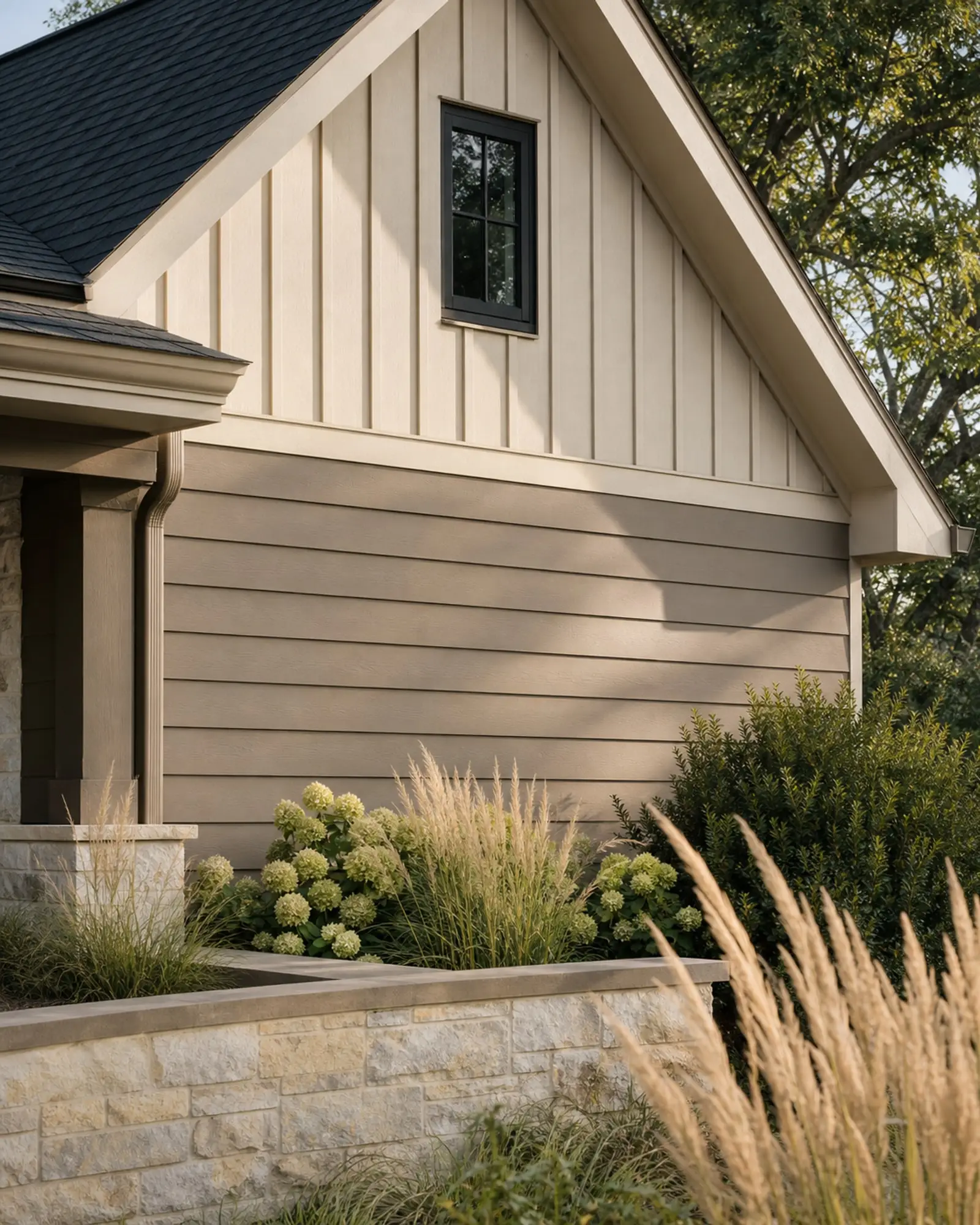 Greige lap siding and cream board-and-batten gable above a limestone garden wall — representative concept image