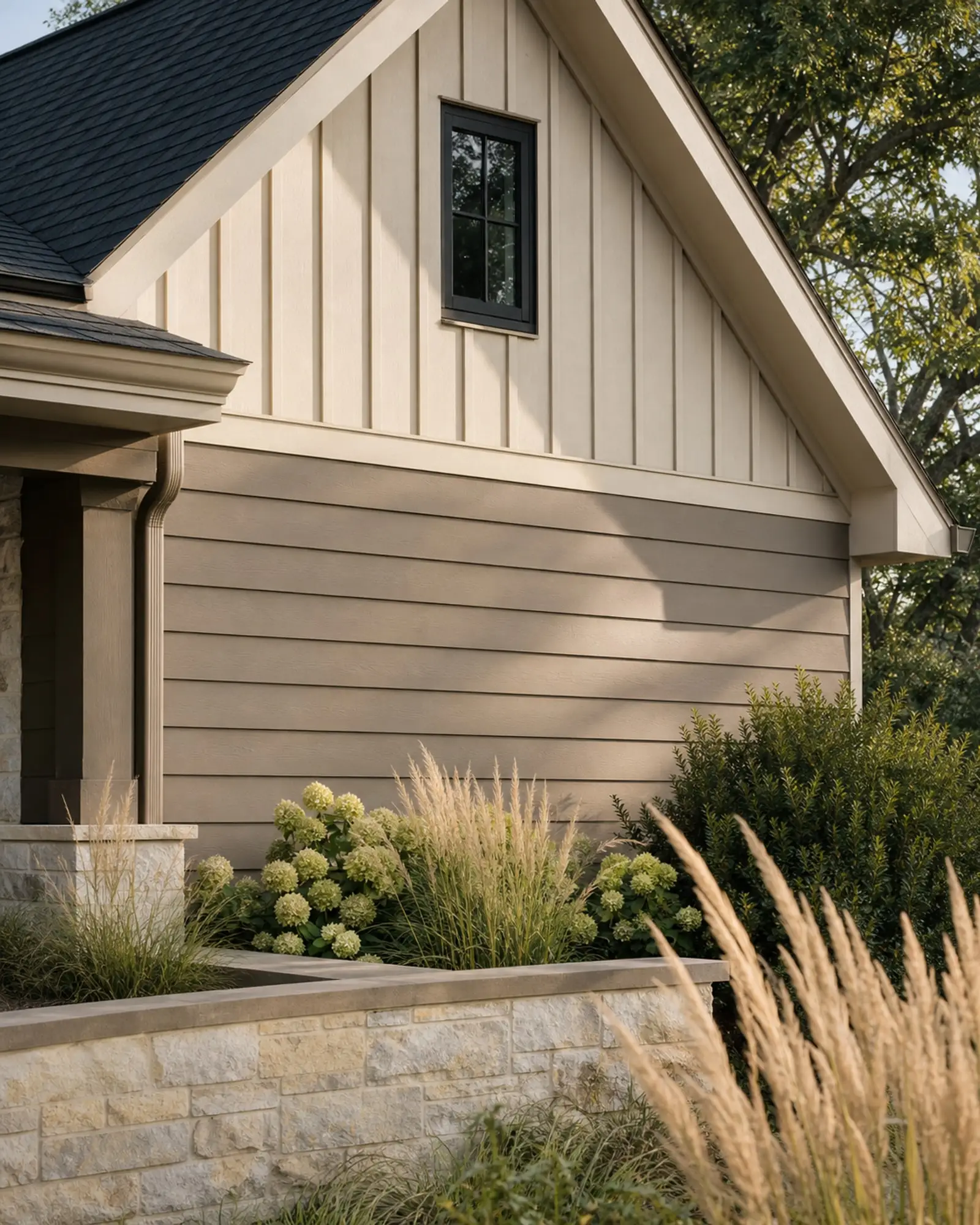 Greige lap siding and cream board-and-batten gable above a limestone garden wall — representative concept image